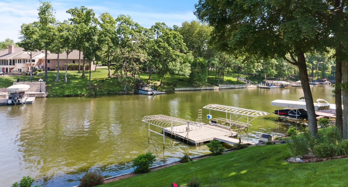 Private docks along a Lake St. Louis cove with waterfront homes and boat lifts on the big lake